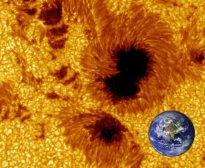 One sunspot can be larger than Earth. It appears dark but it's just not as bright as the surrounding plasma